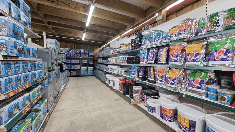 A Picture Of an aisle in Fathoms Aquatics' Pond Goods section
